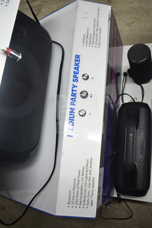 "Store display featuring Onn Medium Party Speaker, Bluetooth, 200W power, 20-hour playtime, multicolor LED, in new condition."