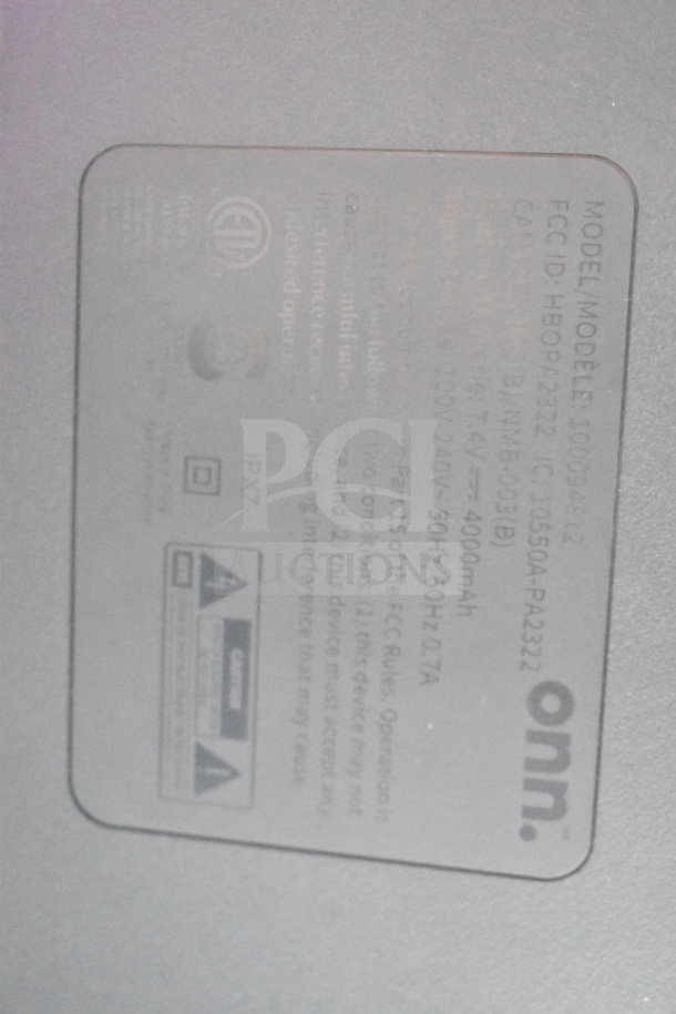 Onn medium party speaker label showing model 100098492, FCC ID, IC details, and IPX7 rating.