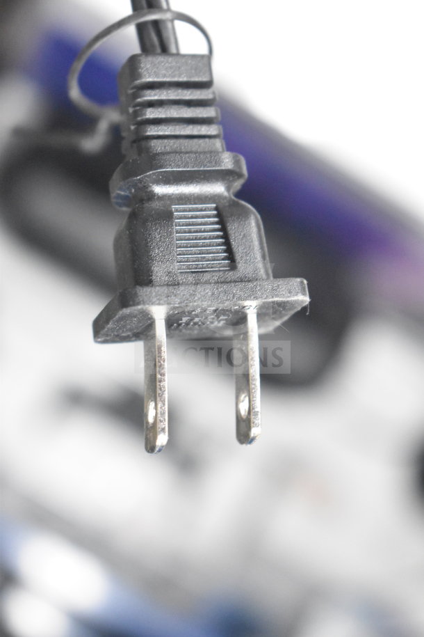 Power cord plug, close-up view, likely part of store display featuring Soundcore Anker Speaker. Features standard prongs.