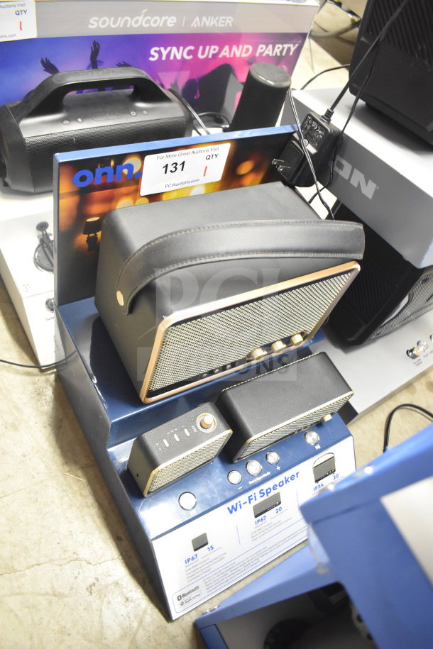 Store display featuring Soundcore Anker Wi-Fi speaker, multiple models, with controls, in working condition.