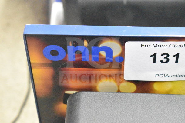Store display featuring Onn Wi-Fi speaker, includes vibrant graphics and product details. Auction label visible, item 131.