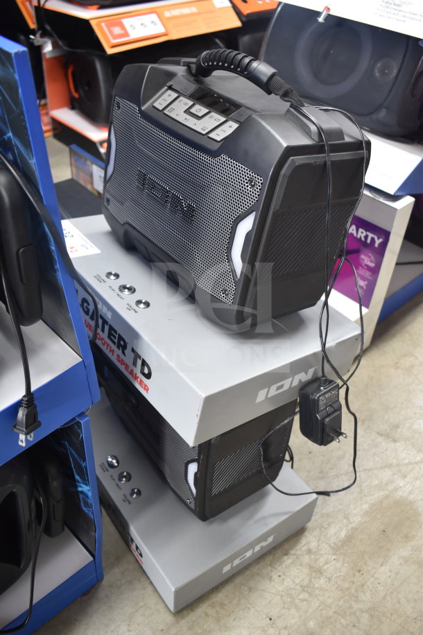 Ion Bluetooth speaker store display, featuring rugged design, button controls, and charger. Display boxes included.