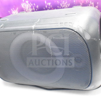 Onn Medium Party Speaker, store display with visible wear, power cord attached, gridded front panel, scratch marks.