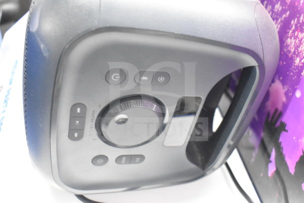 Onn Medium Party Speaker display, featuring control buttons and volume dial, in excellent condition for auction.