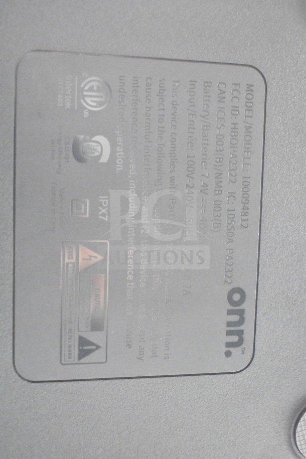 Onn Medium Party Speaker label showing model 100094812, IPX7 rating, FCC ID HBOPA2332, and input details.