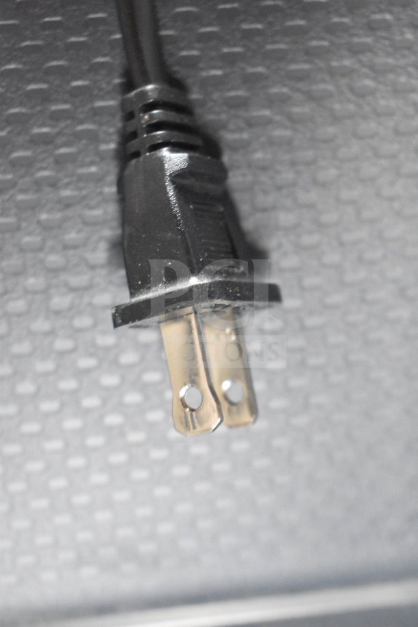 Close-up image of a power plug component. Features a black plastic casing with metal prongs.