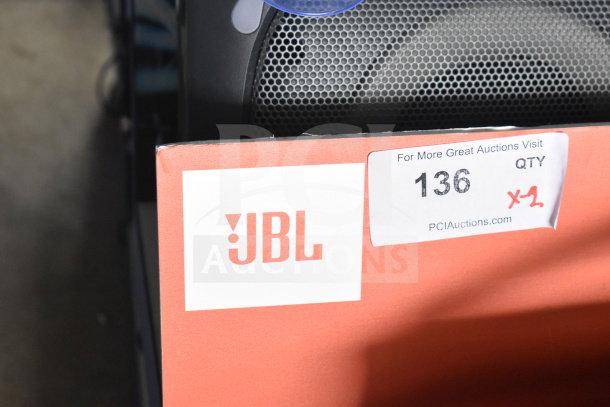 JBL Boombox 3 speaker in store display, labeled "Lot 136, Qty x2," from PCI Auctions.