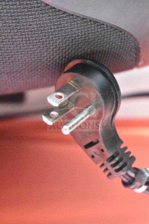 Close-up of a JBL Boombox 3 with power plug, highlighting textured speaker fabric and sturdy plug for secure connectivity.