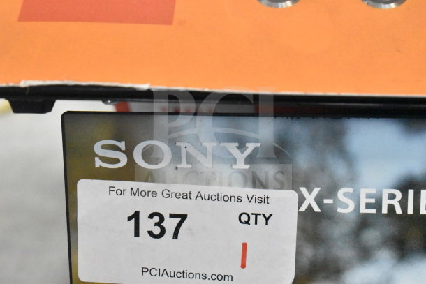 Store display for Sony XE200, XB13, XE300 speakers; features Sony branding; auction tag shows "137 QTY 1".