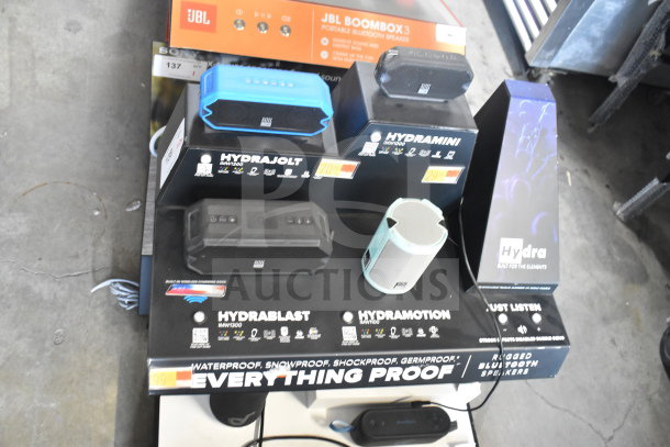 Display of Altec Lansing Hydra series speakers, including Hydramotion model. Waterproof and shockproof features visible.