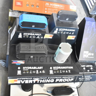 Display of Altec Lansing Hydra series speakers, including Hydramotion model. Waterproof and shockproof features visible.