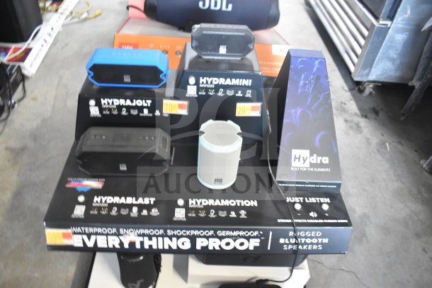 2-store display featuring Hydrajet Hydramotion speakers; waterproof, shockproof, snowproof, various models and prices shown.