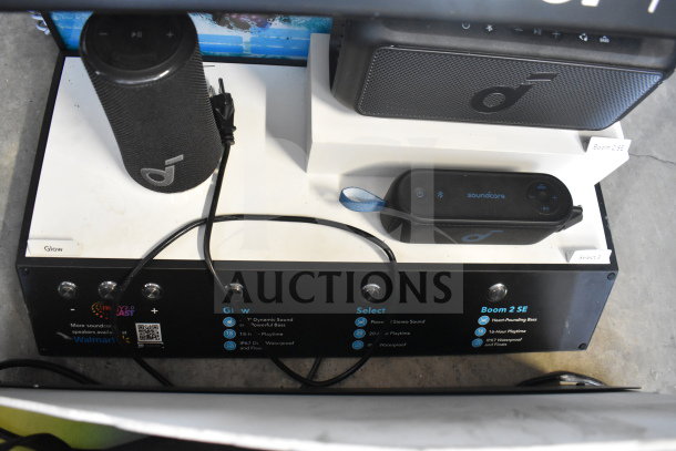Store display with Hydrajet Hydramotion speaker, includes Soundcore models. Features dynamic sound and waterproof design.