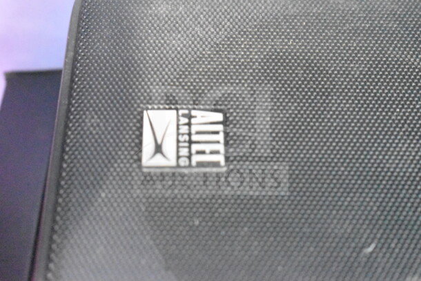 Alt text: Altec Lansing speaker with branded logo on textured surface, part of a store display including Soundcore speaker.