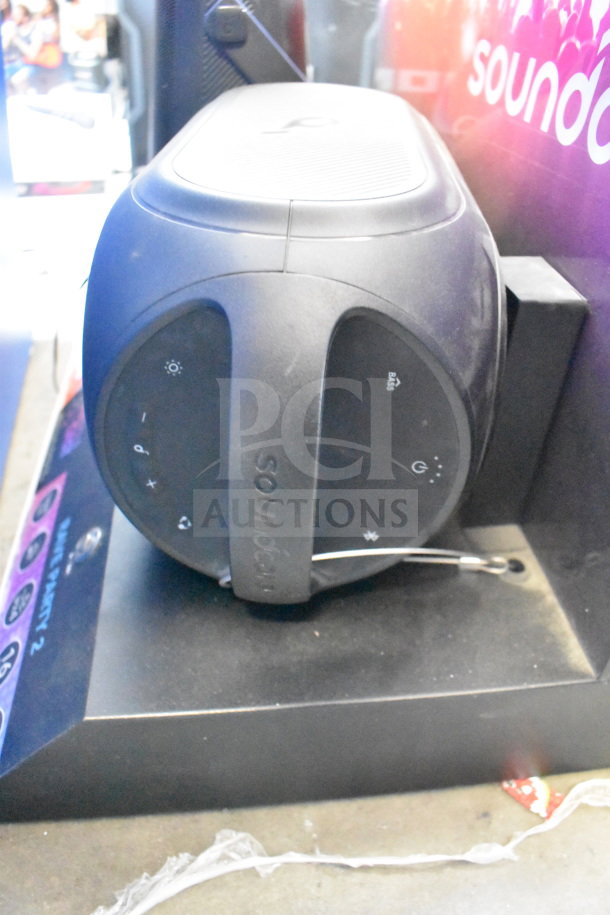 Store display featuring Altec Lansing and Soundcore speakers. Includes item logos and control icons.