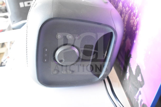 Alt text: Onn Medium Party Speaker display panel with control buttons and volume knob, part of store display set.