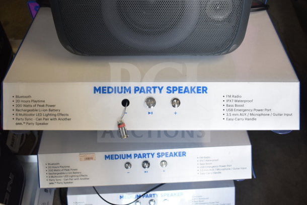 Onn Medium Party Speaker display, featuring Bluetooth, 20-hour playtime, 200W peak power, IPX7 waterproof, and FM radio.