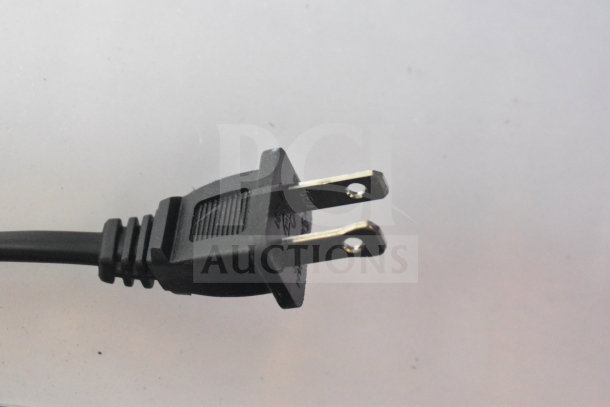 Close-up of a standard black power plug with metal prongs, connected to an electrical cord.