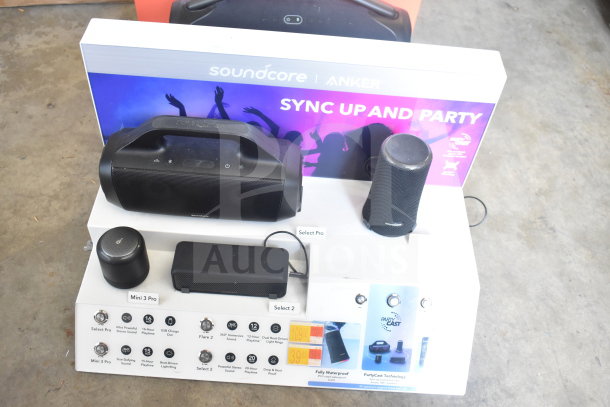 Store display featuring JBL Boombox 3 and Soundcore speakers. Includes Select Pro, Mini 3 Pro, new condition.