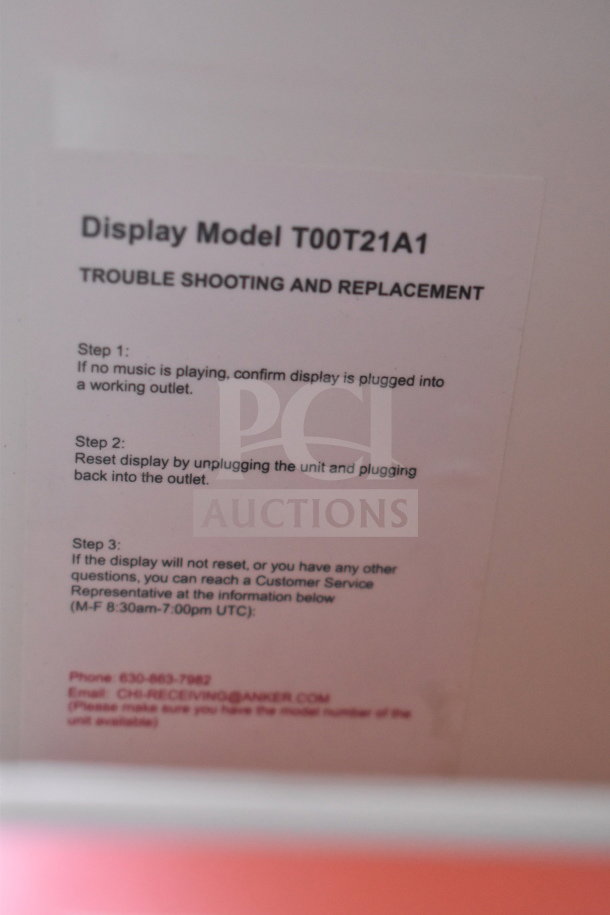 Display unit with JBL Boombox 3 and Soundcore Speaker. Tag: "Display Model T00T21A1" with troubleshooting steps.