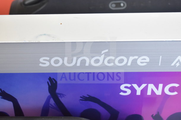 Display showing the Soundcore logo and JBL Boombox 3 speaker in background. Ideal for store promotion.