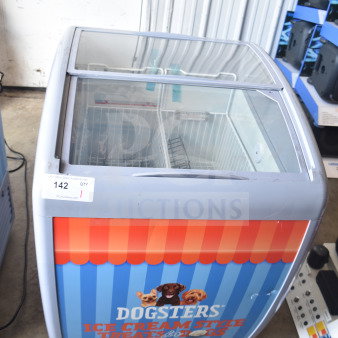 Commercial chest freezer merchandiser, 115 volts, 1 phase, featuring "Dogsters" branding, sliding glass top. In good condition.