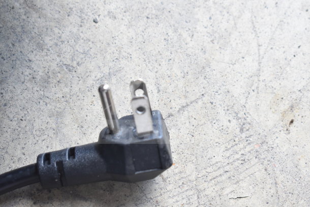 Commercial chest freezer plug for XS-160Y model, 115 volts, 1 phase, on concrete surface.