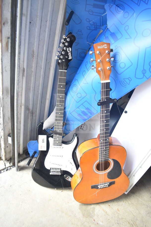 Two Rock Jam guitars, electric and acoustic, in good condition. Visible auction tag "145."