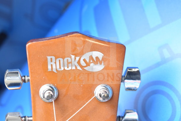 Rock Jam guitar headstock with logo, showing silver tuners; good condition, ready for auction bidding.