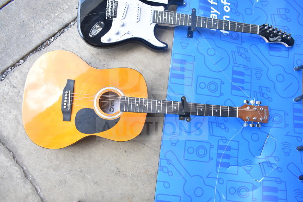 Two Rock Jam guitars, one electric in black and one acoustic in natural finish. Both appear in good condition.