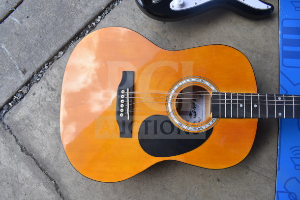 Two Rock Jam guitars; one acoustic with orange finish, one black electric, both in good condition. Auction item.