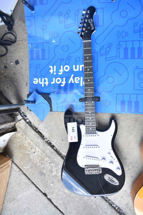 Black Rock Jam electric guitar with white pickguard, 6 strings, in used condition. Auction tag indicates lot 145.