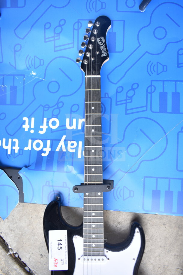 Two Rock Jam electric guitars, black and white, with a modern design. In good condition with visible auction tag "145".