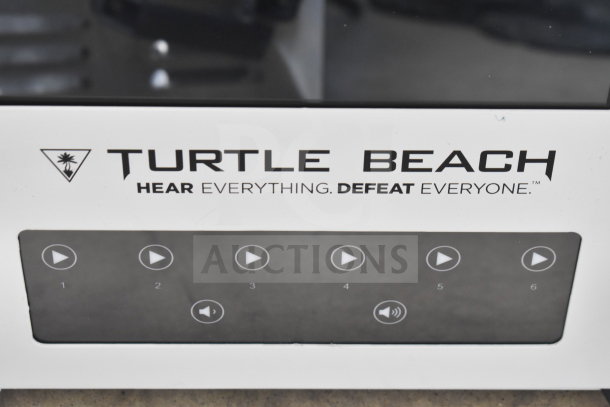 Turtle Beach store display featuring headphone controls, "Hear Everything. Defeat Everyone" slogan, and logo on white panel.