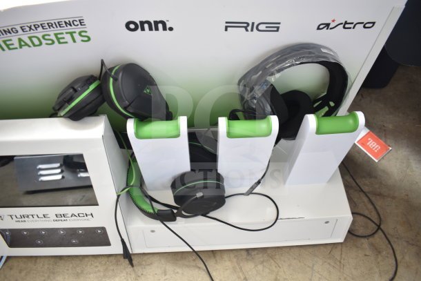 Store display featuring multiple gaming headsets by onn., RIG, Turtle Beach, and Astro. Includes headset holders.