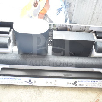 Store display featuring ONN 5.1.2 surround soundbar system with various speakers, subwoofers, and soundbar. New condition.