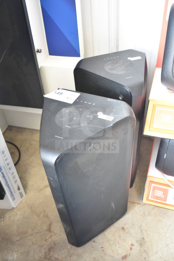 Two Samsung MX-ST4CB speakers, black, slightly dusty. Tags show item number 149, bid multiplier x2. Good condition.