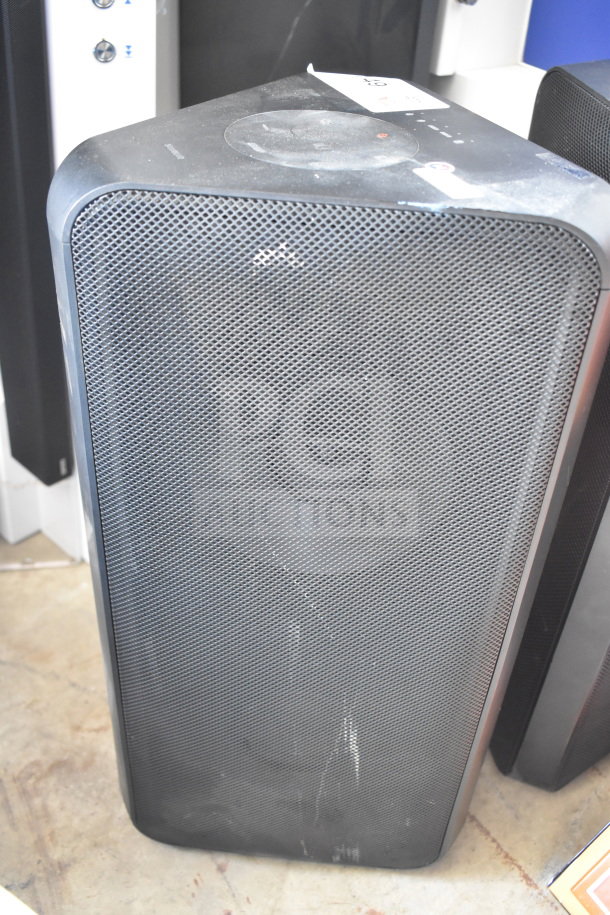Samsung MX-ST4CB speaker, black, good condition, slight surface wear, featuring a mesh grille and top controls.