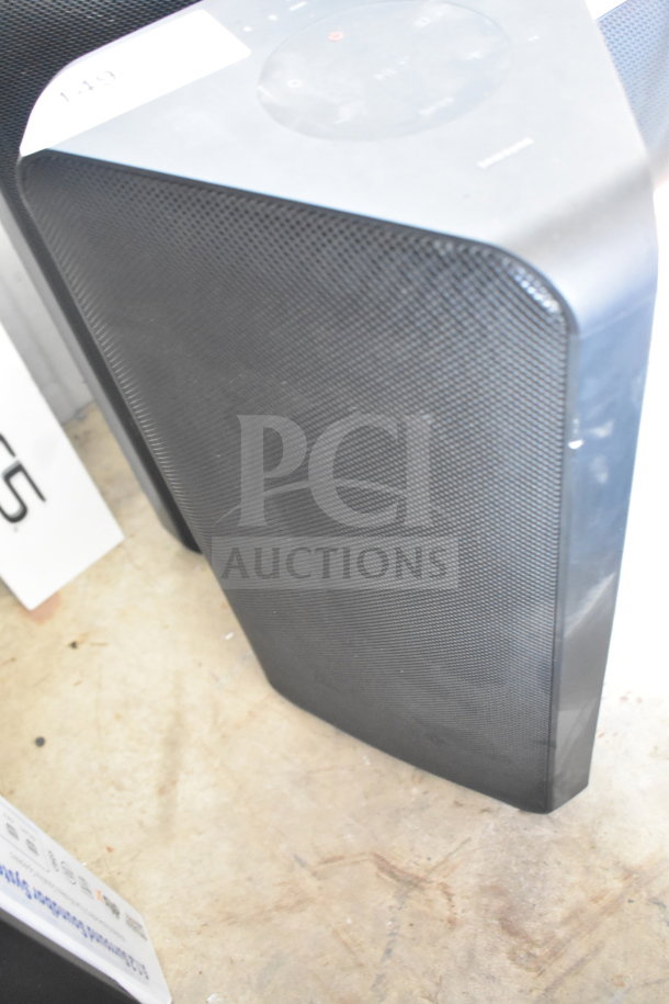 2 Samsung MX-ST4CB speakers, black finish, minimal wear. Top control panel visible. Auction label with number.