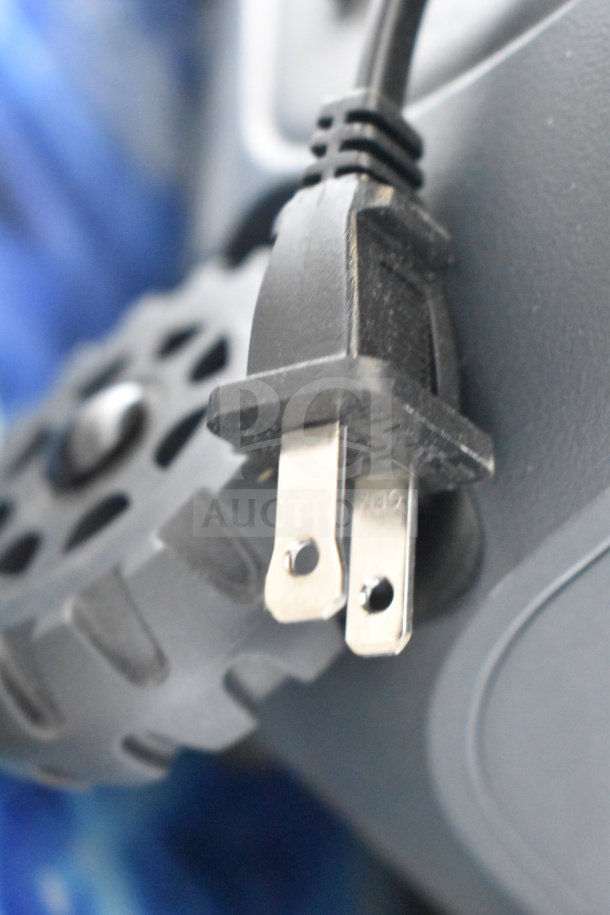 Power plug of Onn Large Party Speaker, part of a store display. Speaker features durable design and high-quality sound.