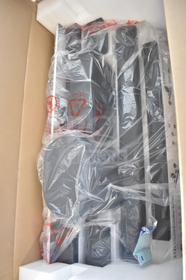 Boxed store display with Onn speakers and soundbars in plastic wrap, new condition, packaging intact.