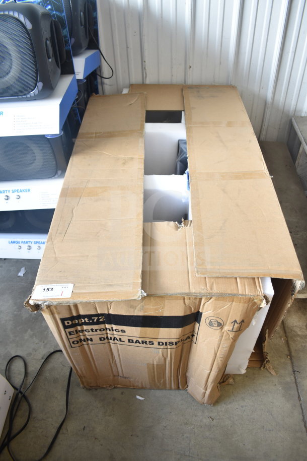 Open cardboard box with Onn speakers and soundbars display. Box labeled "Dept. 72 Electronics ONN DUAL BARS DISPLAY."