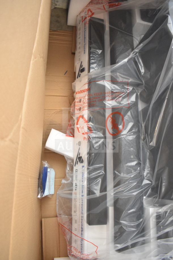 Onn speakers and soundbars in a store display, wrapped in protective plastic, in cardboard packaging.