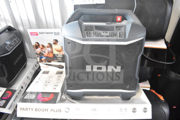 Ion Party Boom Plus speaker on display stand, features Bluetooth connectivity and microphone inclusion, excellent condition.