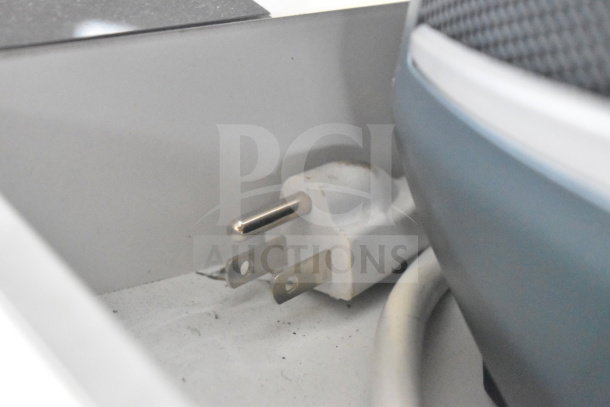 Store display with Ion Party Boom Plus speaker, visible power plug on white shelf; condition not fully visible.