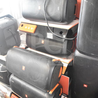 JBL speaker display, five units stacked; black with orange trim. JBL logos visible. Auction item, condition appears used.