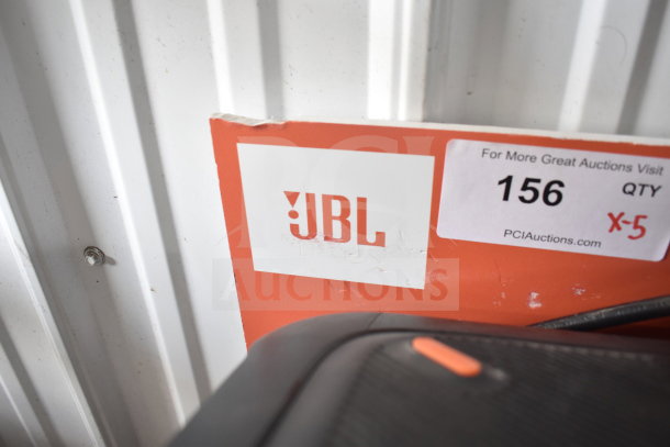 JBL speaker on store display, auction tag "156 QTY X-5," by PCIAuctions.com, rugged design, promotional value.