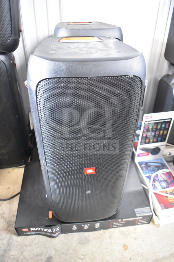 JBL Partybox 310 speaker on display, black with a front grille and red logo. Store display model, good condition.