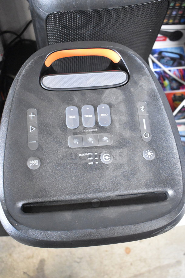 JBL Partybox 310 Speaker with visible control panel, featuring buttons for bass, treble, echo, Bluetooth, and power.