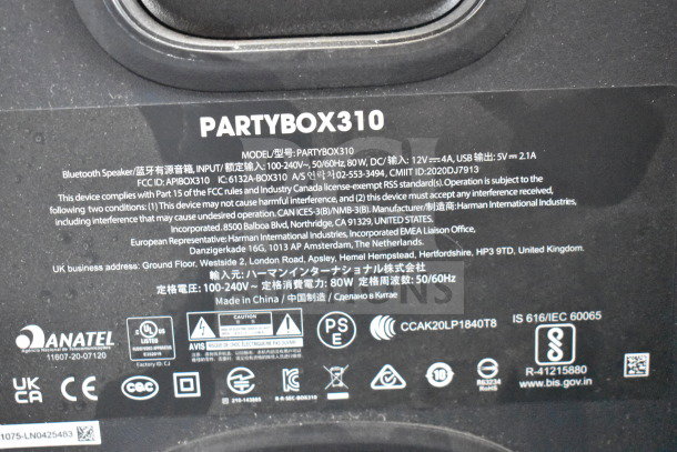 Close-up of JBL Partybox 310 speaker label detailing specifications, compliance information, and manufacturing details.